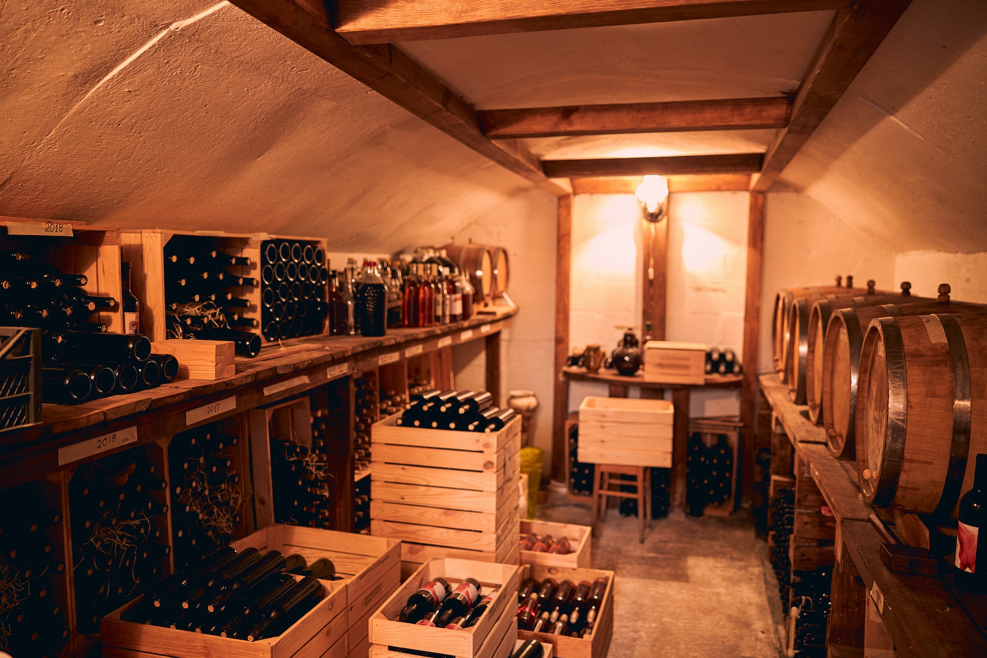 Storage room with wine in bottles and barrels